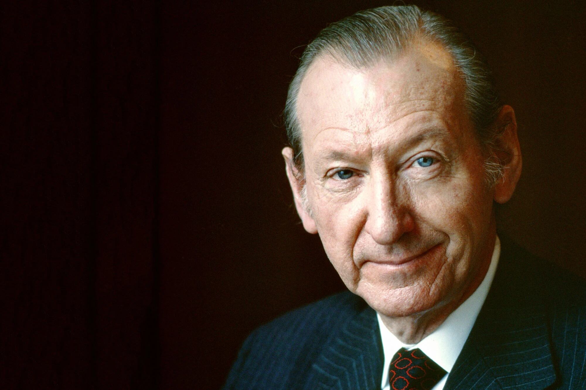 Portrait of Kurt Waldheim, the fourth Secretary-General of the United Nations, wearing a dark pinstripe suit and tie.
