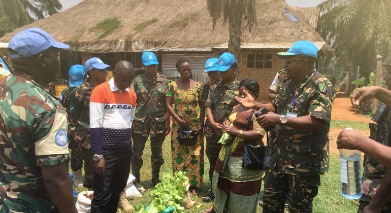 Tanzanian peacekeeper, Ahmed Liuma (far right) serving with MONUSCO’s FIB force in Mavivi, Beni Town in the the Democratic Republic of the Congo, DRC’s province of North Kivu explaining to women farmers on how to sustainably farm vegetables for both selli