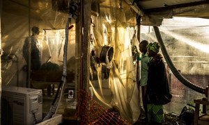 Parents visiting her 15-year-old daugher, who is suspected of being infected by Ebola, at the Ebola Treatment Center in Beni, DRC (January 2019).