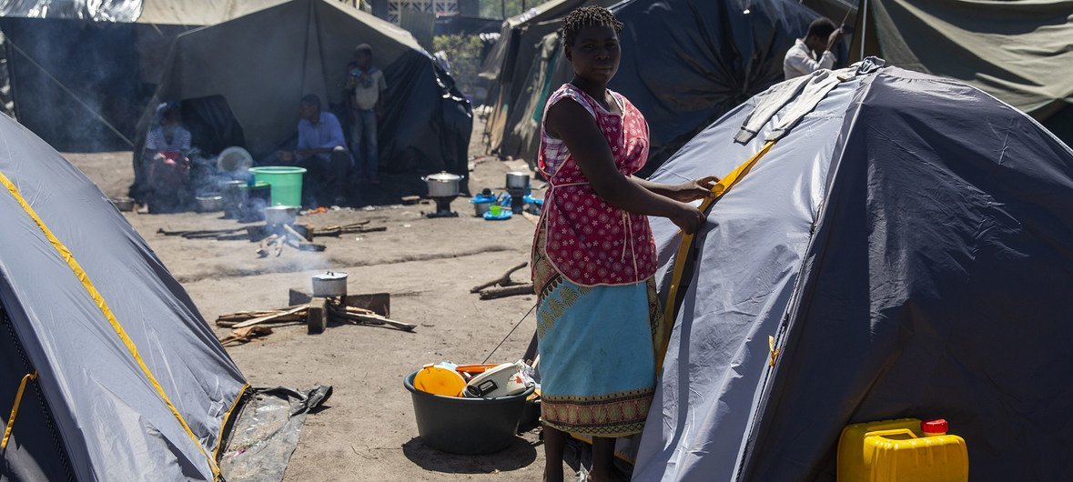Esther next to a tent she lives in at a camp set up for displaced people at the Jehovas Witness Centre in Dondo, Mozambique. Cyclone Idai displaced thousands of people.