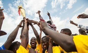 Football players celebrate the first prize at the closing ceremony of the community football competition in Zam Zam camp for internally displaced persons in North Darfur.