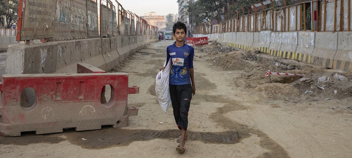 Mohamed supports his family by collecting plastic bottles for recycling, in Bangladesh.