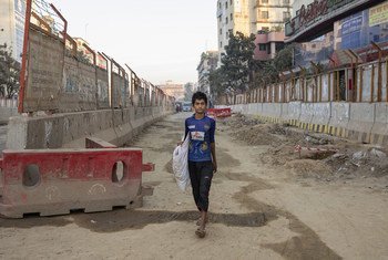 Mohamed supports his family by collecting plastic bottles for recycling, in Bangladesh.