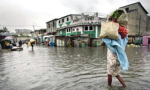 A woman walks through a flooded market in Port au Prince, Haiti, after Hurricane Sandy wreaked havoc on the Caribbean island in 2012.