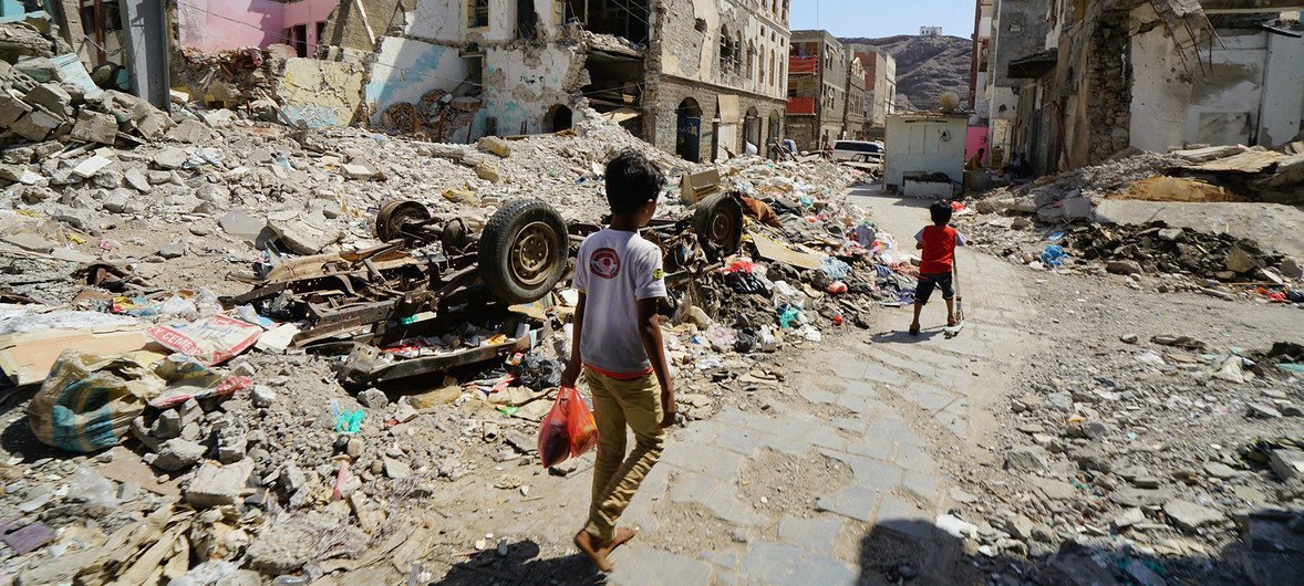 Children walk through a damaged part of Craiter city center in Aden, Yemen.  The area was heavily damaged by air strikes in 2015 when the Houthis were driven from the city by coalition forces.