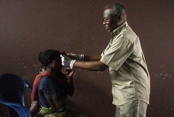 Télesphore Mumbere, ophtalmologue à la clinique de Butembo, ausculte une personne ayant survécu à Ebola.