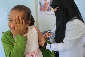 A child in Sana’a braces for a Measles and Rubella vaccination given by a local health worker through a UNICEF-backed campaign in Yemen's Bani Alhareth, February 2019. 