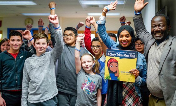 Children’s book author and former Somali refugee Habso Mohamud poses with students after a book reading at a middle school in the Washington, DC area. 