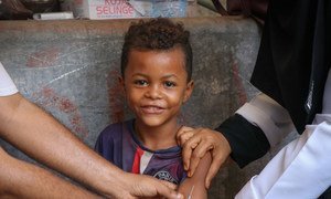 A child smiles while receiving a Measles and Rubella vaccination during a UNICEF-supported mobile vaccination campaign in Aden, Yemen, February 2019.