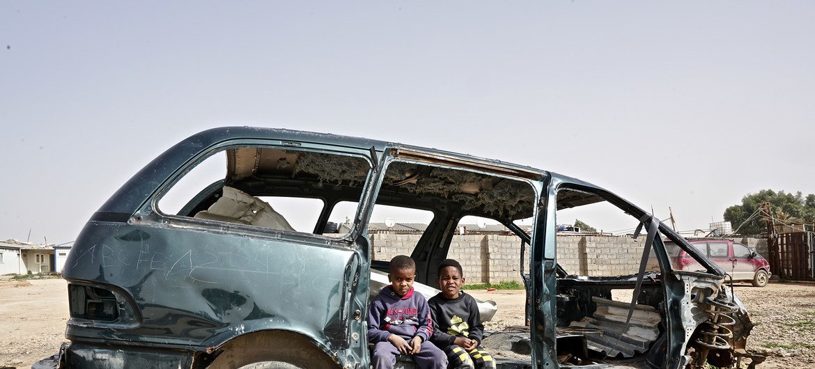  IDP Tawerghan children in a damaged car in the Qaryounis IDP settlement in Benghazi. The Qaryounis settlement is home to 204 families almost all of whom were displaced from Tawergha in 2011.