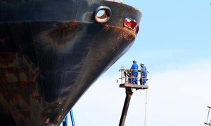 A cleaning operation is being undertaken to remove organisms which have built up on a ship's hull. (1 June 2016)