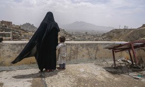 Khairy Hussain and her daughter Fawzia look over the city of Sana'a from the roof of the dilapidated building where they have sought refuge. (1 May 2017)