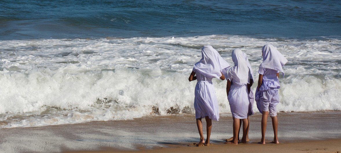 At the end of the school day, fifth-grade girls play on the shore in the town of Akkarapattu, Sri Lanka.