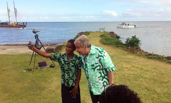 A student takes a selfie with Secretary-General António Guterres during the UN chief's visit to Fiji in May 2019.