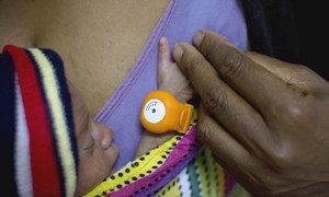 Baby in Papua New Guinea wears an orange hypothermia alert device at the neo natal unit in Mendi General Hospital in Southern Highlands Province to monitor its temperature.