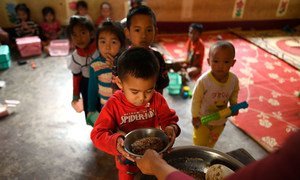 Local school children eat their meals at the Ban Bor Primary School in Xay District, Lao People's Democratic Republic. (14 May 2019)