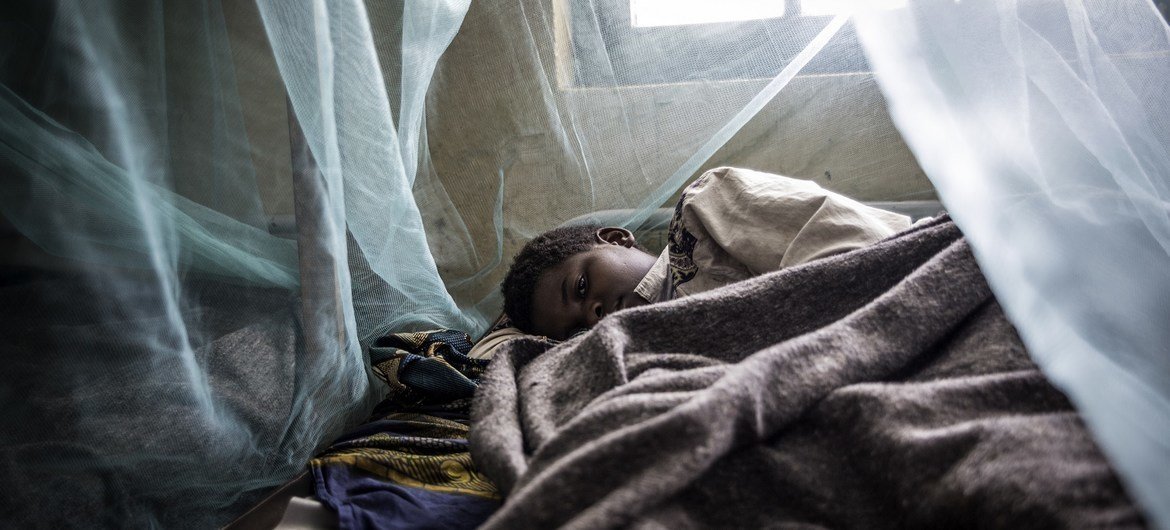 A child sleeps under an insecticide treated mosquito net for protection against malaria.