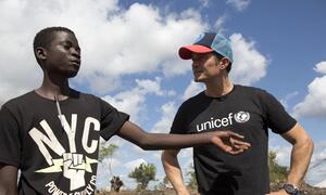 Orlando Bloom fala com Fernando Branguihoul, 19 anos, deslocado pelo impacto de ciclones recentes e agora vivendo no Local de Reassentamento Mutua, Moçambique.