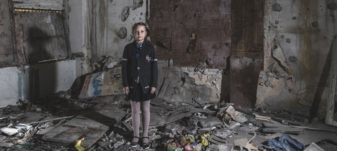 Masha Khromchenko se tient debout dans une salle de classe de maternelle qui a été directement touchée par un obus dans la région de Louhansk, en Ukraine. (archive : 23 septembre 2018)