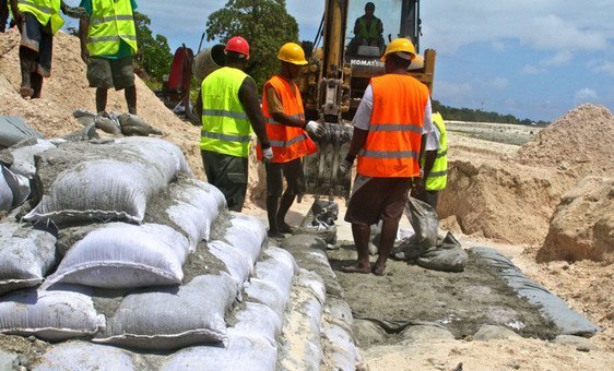 Building seawalls along the coastline in Tarawa, Kiribati, to to protect against high tides or tsunamis.