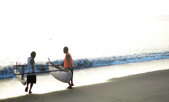 Fishermen on Vanuatu's Malekula Island launch their outrigger canoe.