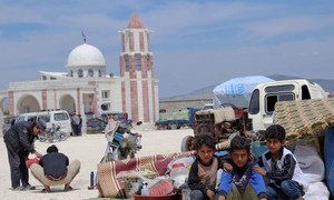 After spending many days in the open, families fleeing hostilities are sheltering in group tents provided by the Turkish Red Crescent near Kafr Lusein, Syria (May 2019).