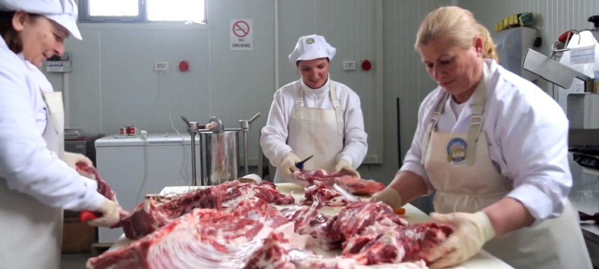 Serbs and Albanian women working together in a butchery in Kosovo.