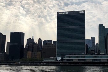 UN Headquarters against sun rays beaming from cloudy skies