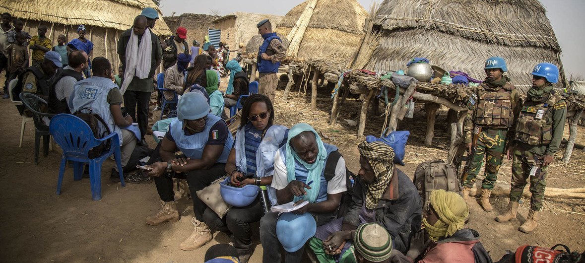 UN human rights investigators accompanied by peacekeepers from the UN mission in Mali, MINUSMA, meet villagers in central Mali after their homes were attacked in February 2019.