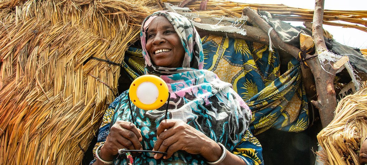 Hauwa's solar lights help her cook and do other chores around her home in Nigeria, and it helps her kids study.