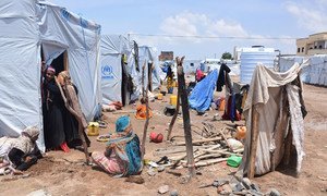 Displaced people sit inside their hosting site in the Yemeni city of Aden after it was hit by heavy rains. (10 June 2019)