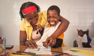 Eight-year-old Filomena, born with spastic quadriplegia and epilepsy, and her mother colour in drawings at the psychosocial rehabilitation centre in Maputo, Mozambique. (8 October 2018)