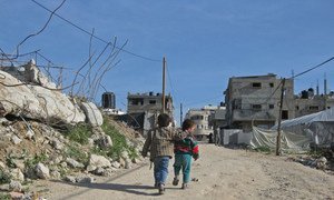 Children walk on road in Gaza, where the UN Relief and Works Agency for Palestine Refugees (UNRWA) maintain food assistance to over one million Palestine refugees.