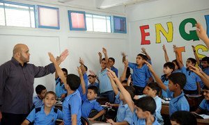 Palestinian boys raise their hands during one of the first classes of the new academic year, at a school in Gaza supported by the United Nations Relief and Works Agency for Palestine Refugees in the Near East (UNRWA).