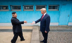 US President Donald Trump shakes hands with the Chairman of the Workers’ Party of Korea Kim Jong-un as the two leaders meet at the Korean Demilitarized Zone which separates North and South Korea on 30 June 2019.