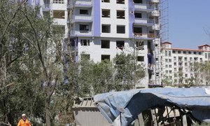 A municipal worker in Kabul, the capital of Afghanistan, cleans debris at an apartment complex that was severely damaged in an attack claimed by the Taliban (file photo)..