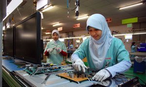 Workers assembling and manufacturing electronic goods at a products factory in Indonesia.