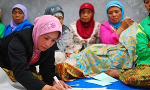 Indonesian women in Yogyakarta discuss village reconstruction during a community meeting.
