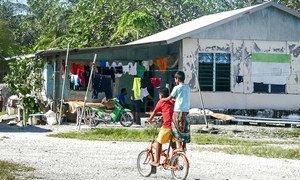 Children riding a bicycle in Tuvalu.