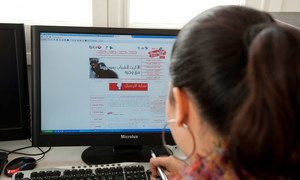 A young woman works on a computer in Tunisia. A joint declaration by global rights experts urges States to recognize people’s right to use the Internet as “an essential condition” for them to express their views. 