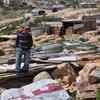 A little boy stands on the remains of his family's demolished home in the West Bank. (File) 