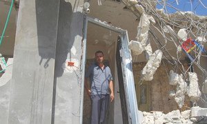 A man stands in what remains of his house in the West Bank after its demolition by the Israeli authorities in September 2018.