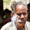 Mr. Bath, 80, is smoking his home grown tobacco in the village of Ban Naseur, Attapeu, Laos.