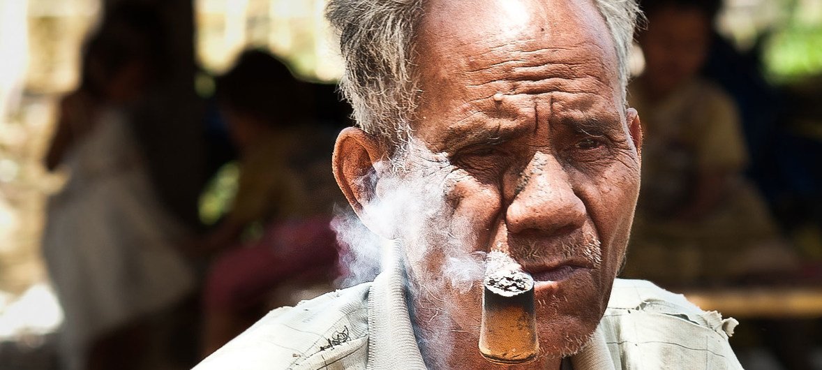 Mr. Bath, 80, is smoking his home grown tobacco in the village of Ban Naseur, Attapeu, Laos.
