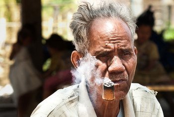 Mr. Bath, 80, is smoking his home grown tobacco in the village of Ban Naseur, Attapeu, Laos.