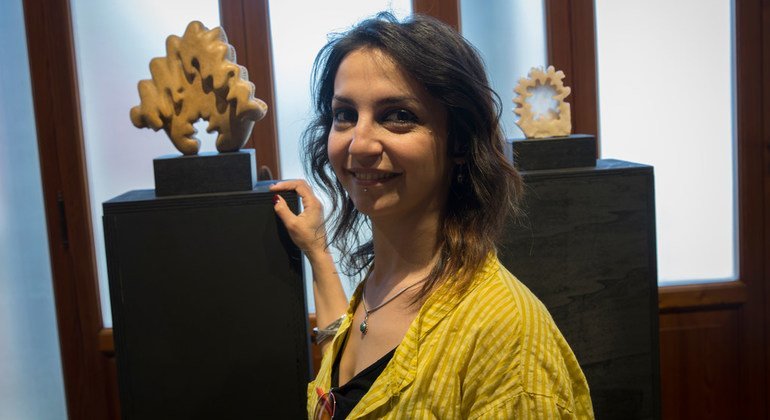 Syrian refugee artist Rasha Deeb, 30, pictured with her scupltures during the 